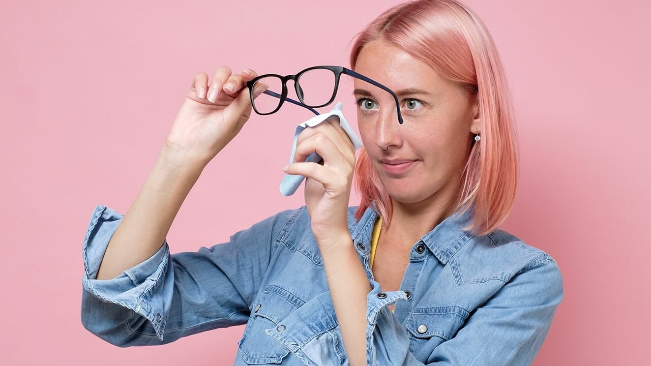 woman cleaning eyeglasses ss1794489121